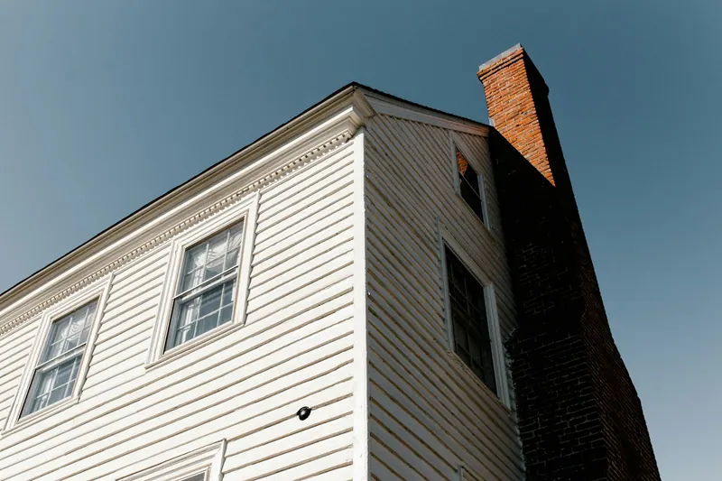 Brick chimney on a white clapboard house