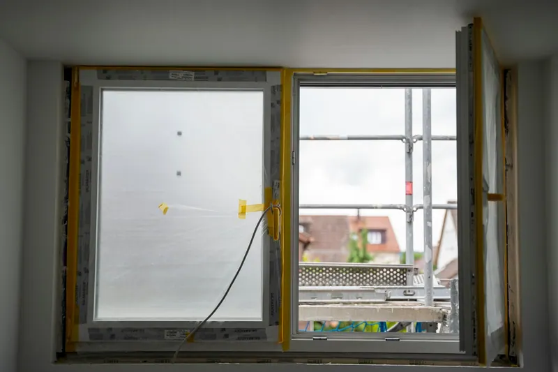 Window opening during a replacement, with the new frame being fitted